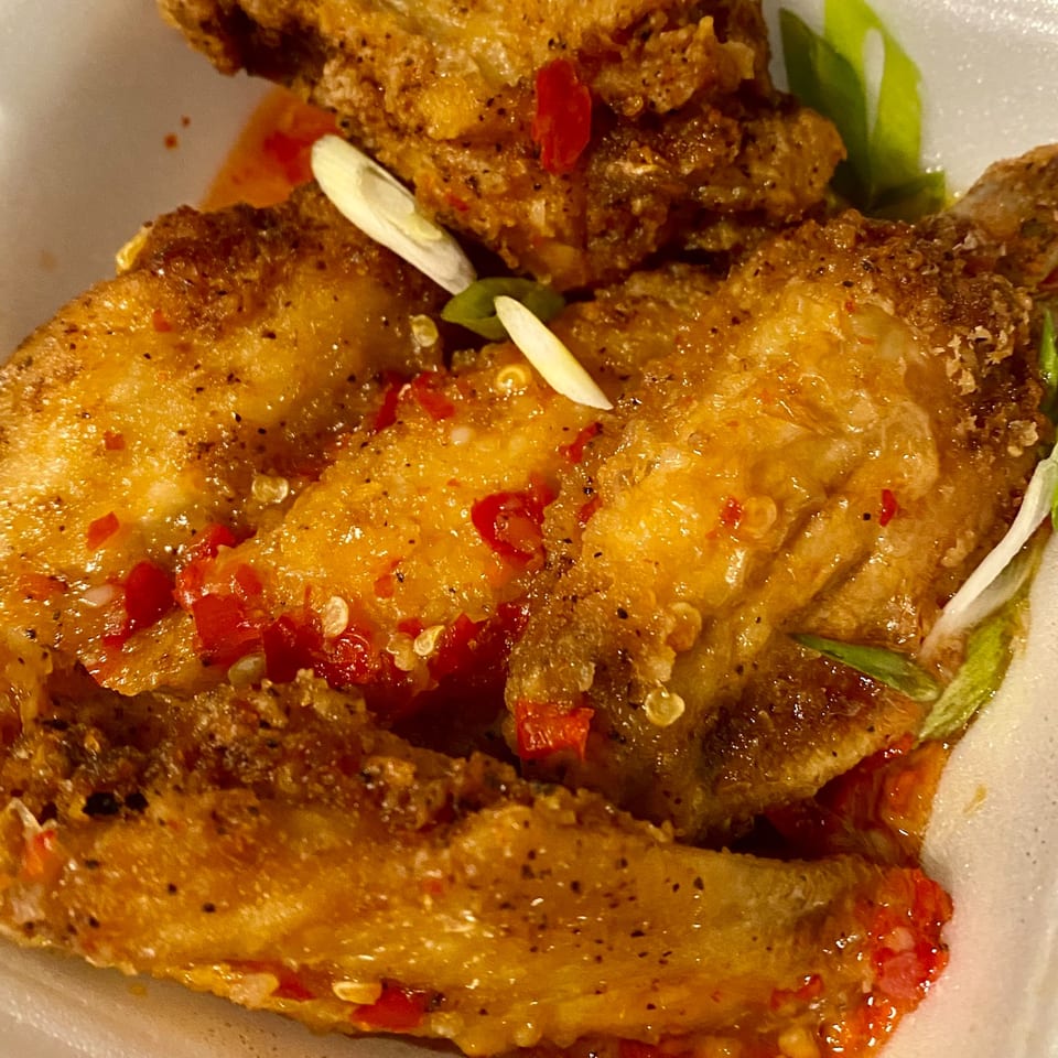 Crispy Vietnamese chicken wings with red chili, green onions, and a sweet and spicy glaze.